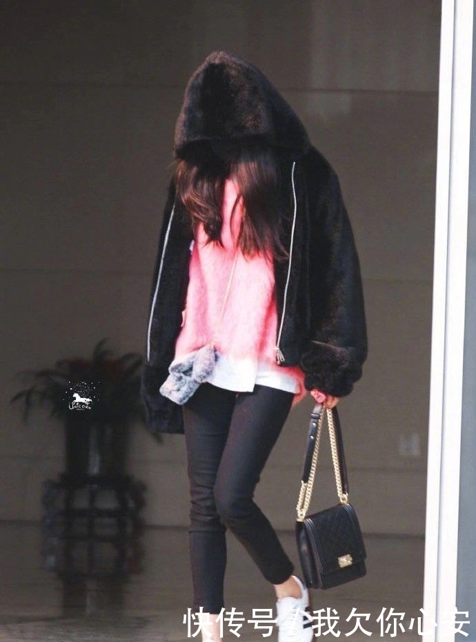 杨幂戴着口罩现身机场,黑色毛绒外套内搭粉色
